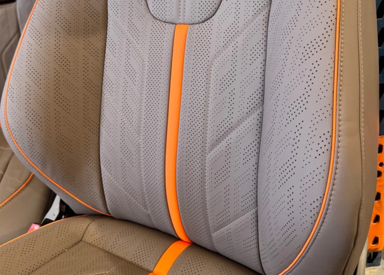 Grey Signature vinyl with perforation, stitching and orange piping