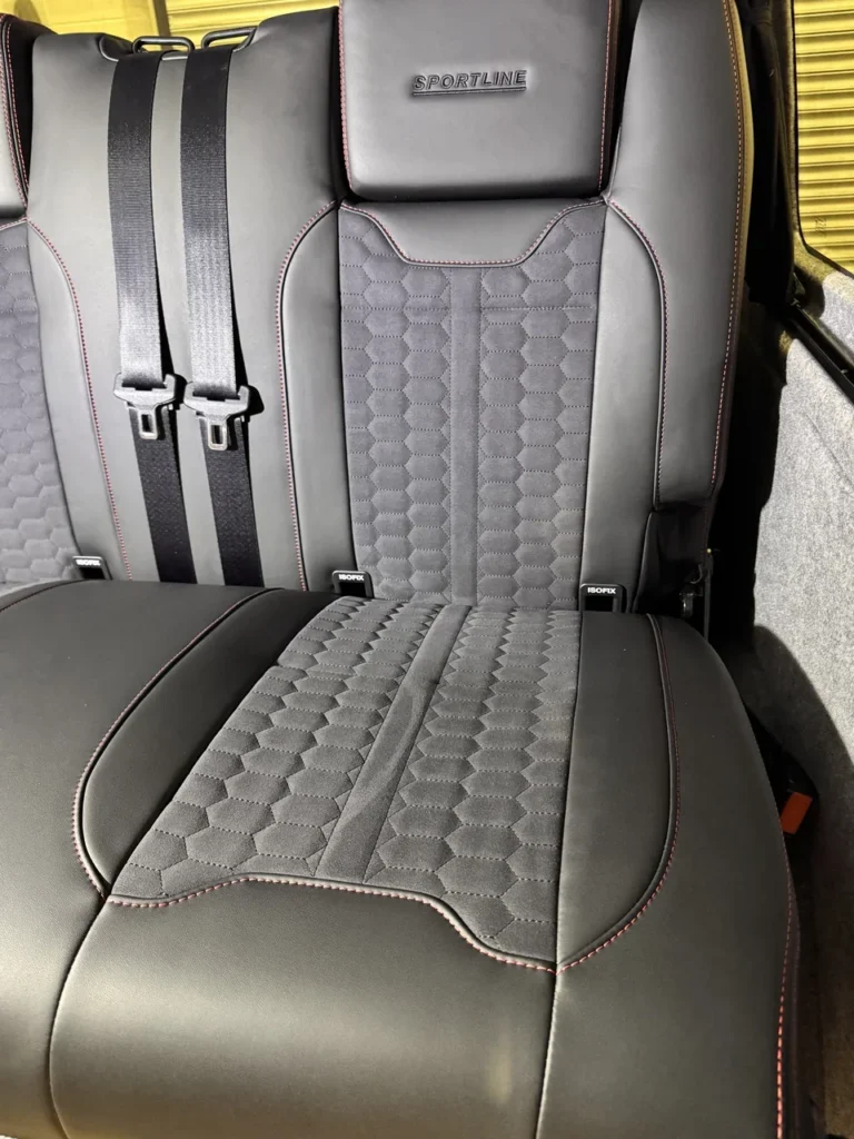 Signature rear-bed stitching and cushion detail